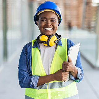 ASHE PDC Summit attendee type: Construction Professionals | A construction professional holds plans and smiles